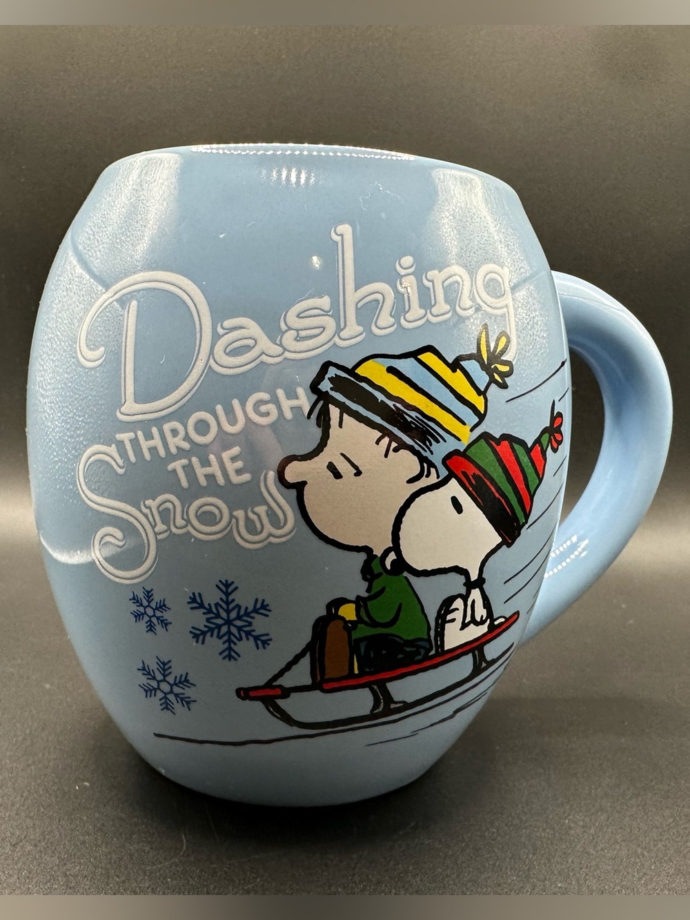 Peanuts Light Blue Ceramic Mug with Snoopy Linus Sledding Graphic